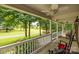 Relaxing front porch with rocking chairs overlooking a lush green lawn and mature trees at 635 Timberlane Trl, Salisbury, NC 28147