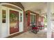 Cozy front porch featuring rocking chairs and a charming view of the landscaped front yard at 635 Timberlane Trl, Salisbury, NC 28147