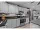 A bright kitchen with stainless steel appliances and gray cabinets at 635 Timberlane Trl, Salisbury, NC 28147