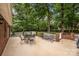 Outdoor patio with a metal dining set and a lush green backyard surrounded by mature trees and privacy at 635 Timberlane Trl, Salisbury, NC 28147