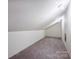 An unfinished attic space with ample potential for storage or customization at 7050 Knightswood Dr, Charlotte, NC 28226
