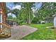 Spacious backyard featuring a screened porch and stone patio, perfect for outdoor entertaining at 7050 Knightswood Dr, Charlotte, NC 28226