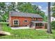 Spacious backyard featuring a brick home, screened porch, and an expansive lawn area at 7050 Knightswood Dr, Charlotte, NC 28226