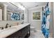 Bathroom with double sink vanity, tub and shower combo, and floral shower curtain at 7050 Knightswood Dr, Charlotte, NC 28226