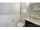 Traditional bathroom with wainscoting, white fixtures, and ample counter space at 7050 Knightswood Dr, Charlotte, NC 28226
