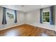 Cozy bedroom features hardwood floors and bright windows at 7050 Knightswood Dr, Charlotte, NC 28226