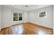Bright bedroom with hardwood floors and two large windows offering great natural light at 7050 Knightswood Dr, Charlotte, NC 28226