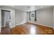A freshly painted bedroom features hardwood floors and two windows for natural light at 7050 Knightswood Dr, Charlotte, NC 28226