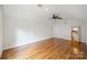 A bright and airy bedroom featuring hardwood floors, a ceiling fan, and multiple closets at 7050 Knightswood Dr, Charlotte, NC 28226