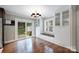 Bright dining area featuring white built-in cabinets, sliding glass doors to the backyard, and hardwood floors at 7050 Knightswood Dr, Charlotte, NC 28226