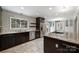 Gourmet kitchen with stainless steel appliances, patterned backsplash, and an island cooktop at 7050 Knightswood Dr, Charlotte, NC 28226