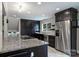 Stylish kitchen with stainless appliances, sleek cabinetry, and a granite-topped island for cooking at 7050 Knightswood Dr, Charlotte, NC 28226