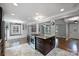 Beautiful kitchen with granite island cooktop and view of the living room, creating a social cooking space at 7050 Knightswood Dr, Charlotte, NC 28226