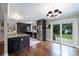 Bright kitchen with granite counters, stainless appliances, dark wood cabinetry, and sliding glass doors to the backyard at 7050 Knightswood Dr, Charlotte, NC 28226