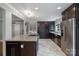 Modern kitchen with granite island cooktop, stainless appliances, an open concept, and classic gray wall paint at 7050 Knightswood Dr, Charlotte, NC 28226