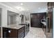 Spacious kitchen with granite island cooktop and stainless appliances, and an open layout to the living area at 7050 Knightswood Dr, Charlotte, NC 28226