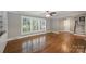 Living room with hardwood floors, large windows, and seamless flow to the adjacent dining or living area at 7050 Knightswood Dr, Charlotte, NC 28226