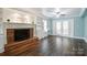 Living room featuring a brick fireplace, built-in shelving, and French doors at 7050 Knightswood Dr, Charlotte, NC 28226