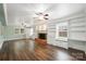 Spacious living room with hardwood floors, fireplace, and built-in shelving at 7050 Knightswood Dr, Charlotte, NC 28226