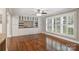 Bright living room with custom cabinets, hardwood floors, and a view of the shuttered window at 7050 Knightswood Dr, Charlotte, NC 28226