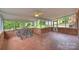 Screened porch with tile flooring and views of the backyard at 7050 Knightswood Dr, Charlotte, NC 28226
