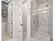 Walk-in shower with white marble, gold fixtures, and glass door, adjacent to walk-in closet at 790 Herrons Ferry Rd, Rock Hill, SC 29730