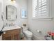 Charming powder room features a marble countertop and wood vanity with gold fixtures and matching wall accessories at 790 Herrons Ferry Rd, Rock Hill, SC 29730