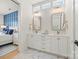 Bright primary bathroom featuring double vanity, gold fixtures, and marble floors, with bedroom in background at 790 Herrons Ferry Rd, Rock Hill, SC 29730