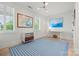 Minimalist bedroom with white walls, bright sunlight, and a blue striped rug at 790 Herrons Ferry Rd, Rock Hill, SC 29730