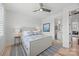 Bedroom with wood floors, ceiling fan, ensuite bath, a bed with blue accents, and a side table at 790 Herrons Ferry Rd, Rock Hill, SC 29730