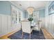 Light-filled dining room with blue accent wall, chandelier and shuttered windows at 790 Herrons Ferry Rd, Rock Hill, SC 29730