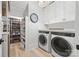 Well-organized laundry room with modern appliances, built-in shelving, cabinets, and ample storage space at 790 Herrons Ferry Rd, Rock Hill, SC 29730