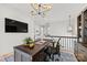 Comfortable office features a dark wooden desk and a modern chandelier at 790 Herrons Ferry Rd, Rock Hill, SC 29730