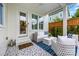 Cozy covered patio with wicker furniture, blue accents, and tiled floors at 790 Herrons Ferry Rd, Rock Hill, SC 29730