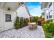 This outdoor patio features tile flooring, a dining table with seating, a grill, and lush, manicured landscaping at 790 Herrons Ferry Rd, Rock Hill, SC 29730