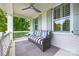 Inviting covered porch with a comfortable wicker couch, ceiling fan, and grey and white accents at 790 Herrons Ferry Rd, Rock Hill, SC 29730