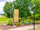 Community signage displaying shops and restaurants at Riverwalk, surrounded by lush greenery at 790 Herrons Ferry Rd, Rock Hill, SC 29730