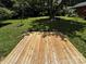 A wood deck in a backyard surrounded by trees and grass at 801 Calhoun St, Lancaster, SC 29720
