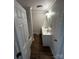 A bathroom with a double sink vanity, updated lighting, and wood-look floors at 801 Calhoun St, Lancaster, SC 29720