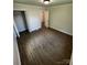 An open bedroom featuring wood-look flooring, a closet, and an open doorway at 801 Calhoun St, Lancaster, SC 29720