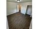 An open bedroom featuring wood-look flooring, a closet, and an open doorway at 801 Calhoun St, Lancaster, SC 29720