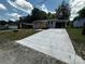 View of the home's long concrete driveway leading up to a newly remodeled house at 801 Calhoun St, Lancaster, SC 29720