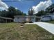 Charming one-story home featuring new siding, a carport, and a freshly poured concrete driveway at 801 Calhoun St, Lancaster, SC 29720