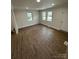 Open-concept living room featuring three windows and wood-look flooring at 801 Calhoun St, Lancaster, SC 29720