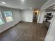 Open-concept living room with three windows and wood-look flooring at 801 Calhoun St, Lancaster, SC 29720