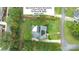 Aerial view of home featuring a well maintained lawn, mature trees, and a roof with solar panels at 8259 Camelia Ln, Denver, NC 28037