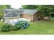 Aerial view of a brick home showcasing a gazebo, solar panels, a deck, and vibrant landscaping at 8259 Camelia Ln, Denver, NC 28037