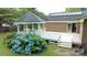 Charming backyard featuring a gazebo, a deck, and vibrant hydrangea bushes near a brick home at 8259 Camelia Ln, Denver, NC 28037