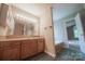 Bathroom features a vanity with ample cabinet space and a large mirror with Hollywood-style lighting at 8259 Camelia Ln, Denver, NC 28037