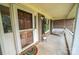 Inviting front porch with swing, brick accents, and a charming entryway creates a warm welcome at 8259 Camelia Ln, Denver, NC 28037